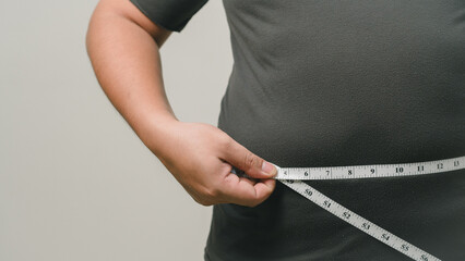 Overweight or obese man on white background. Fat mens body measurements. he is dieting and losing weight. Healthcare, medicine concept. he is dieting and losing weight.