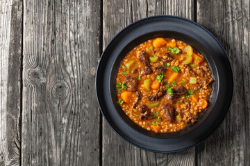 beef barley soup in a bowl, top view