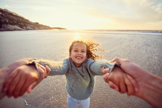 Parent, pov and girl with holding hands at beach for outdoor adventure, vacation and playful fun. Portrait, father and daughter with swing by ocean water for summer holiday, sunset and love in Cancun