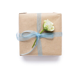 Gift box with blue bow and beautiful rose on white background. International Women's Day