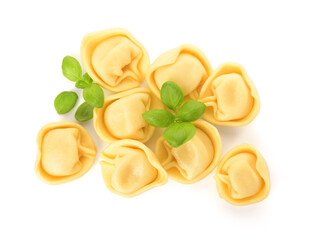 Raw dumplings and basil on white background