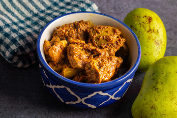 Indian mango pickle is a piquant condiment, bursting with tangy, spicy flavors. Made with raw mango, spices like mustard oil, turmeric, and chili, it's a traditional, homemade delicacy enjoyed across.