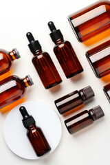Obraz premium Mock up of amber glass bottles on white background flat lay
