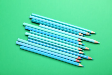 Blue pencils on green background