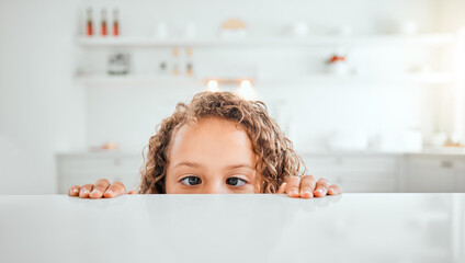 Girl, child and peeking by counter in kitchen for curiosity, snack time and food for eating or...