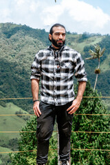 Latin man traveler, happy to know the Cocora Valley in Colombia. Photography, travel and excursion.