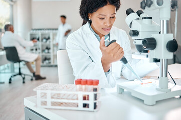 Black woman, scientist, and pipette with blood test in lab for microscope experiment, dna study and...