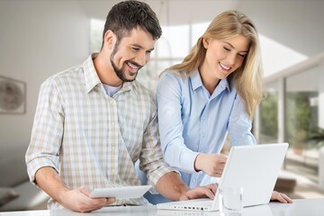 Fototapeta premium Smiling man and woman working on computer