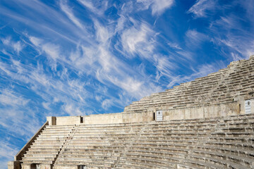 Roman Theatre in Amman, Jordan -- theatre was built the reign of Antonius Pius (138-161 CE), the large and steeply raked structure could seat about 6000 people. Against the sky with clouds