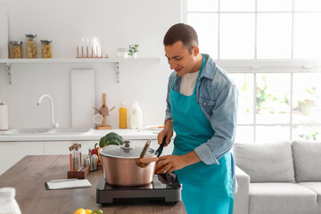 Young man cooking in kitchen