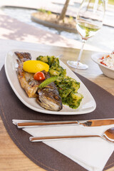Grilled fish served on a plate in the restaurant