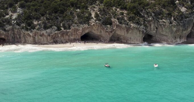 Boats In The Beautiful Turquoise Ocean On The Baunei Coast In Sardinia, Italy.