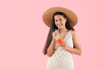 Young woman with aperol spritz cocktail on pink background