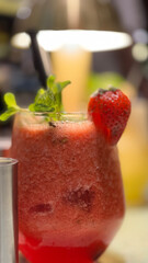 Glass of fresh strawberry drink with basil leaf on grey table, Space for text Vitamin beverage for recipe