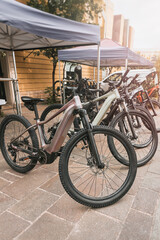 Obraz premium Electric Bikes Parked Outside Urban Shop