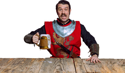 Tasting beer. Portrait of medieval warrior or knight with dirty wounded face holding wooden mug of...