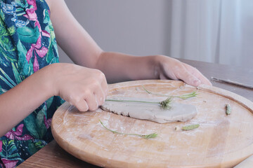 Young teenage girl molding houses out of clay. Hobbies and tools. Creativity for children, education. 