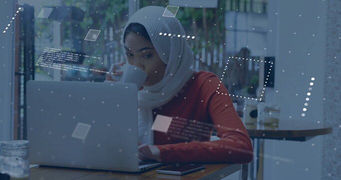 Image of financial data processing over biracial woman in hijab using laptop