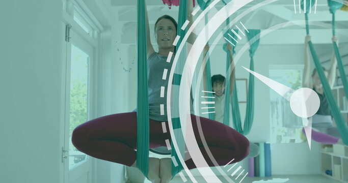 Image of scanner processing over diverse female instructor and teenage girls doing aerial yoga - Powered by Adobe