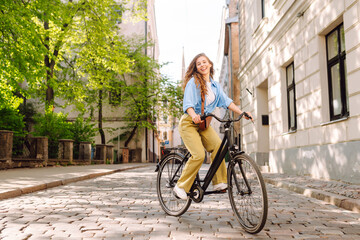Portrait of beautiful young woman enjoying time on bicycle. Active lifestyle. Eco transport.