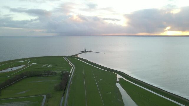 Aerial view of serene lake with iconic lighthouse and peaceful peninsula, Marken, Netherlands.
