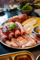 Tray with fresh pork raw and vegetables,ingredients for marinated , ready for cooking in Korean barbecue restaurant.
