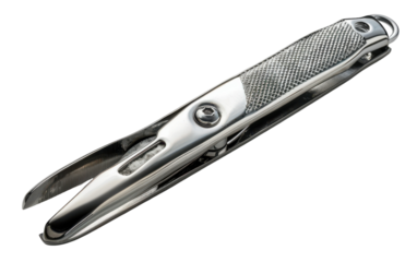 A silver fishing line cutter with a textured grip lies on a white background