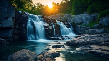 Blur waterfall in forest with sun rising.