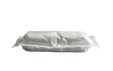 A sealed package of detergent powder sits on a white surface