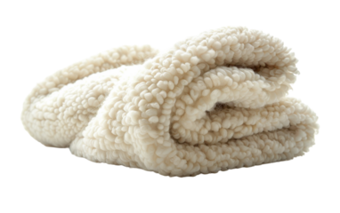 A fluffy, white blanket is rolled up, inviting warmth and comfort