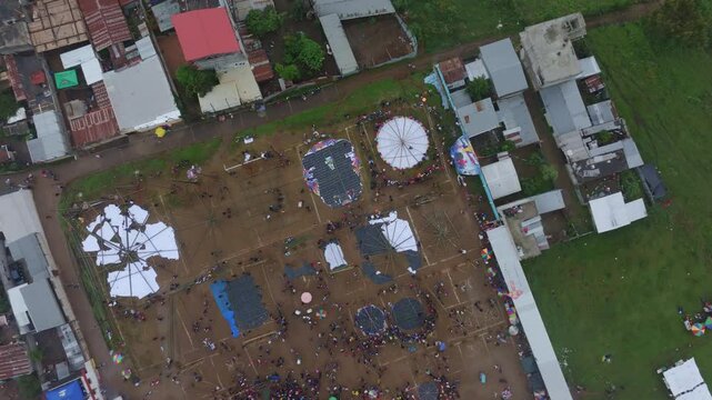 Aerial view of colorful kites festival in crowded Sumpango, Guatemala.