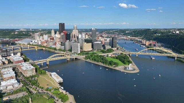 Pittsburgh skyline with the Allegheny, Monongahela, and Ohio Rivers converging. View includes Point State Park and Fort Duquesne Bridge. Aerial, downtown buildings like PPG Place and U.S. Steel Tower.