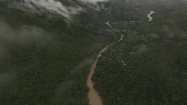 Aerial view of lush rainforest and winding river in Semuc Champey, Alta Verapaz, Guatemala.
