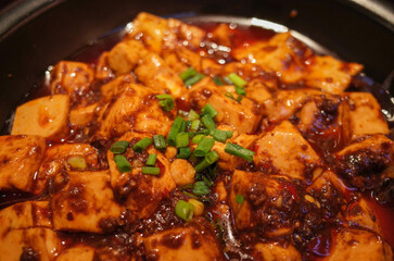 Closeup of mapo tofu in a casserole pan. Bean curd Sichuan style. MaPo Tofu,stir-fried tofu in hot sauce.