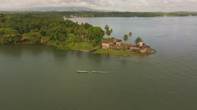 Aerial view of medieval Castillo de San Felipe overlooking lush lake and historic castle, Rio Dulce, Guatemala.