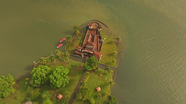 Aerial view of medieval Castillo de San Felipe overlooking a lake with boats, Rio Dulce, Guatemala.