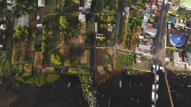 Aerial view of sunrise over city, lake, and volcano, San Pedro La Laguna, Solola, Guatemala.