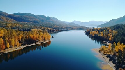 Aerial View of a Stunning Autumn Forest and Pristine Lake with Mountain Backdrop
