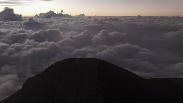 Aerial view of erupting Volcano Fuego with dramatic sunset sky, Chimaltenango, Guatemala.