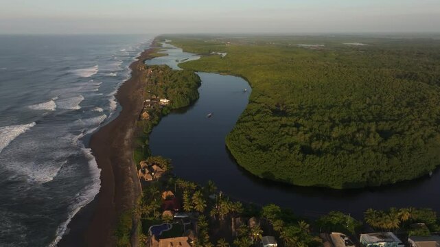 Aerial view of lush greenery and tranquil shoreline in El Paredon, Escuintla, Guatemala.