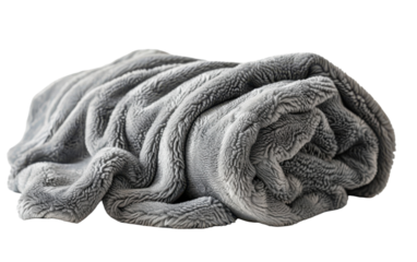 A cozy grey fleece blanket rolled up for a comfortable evening