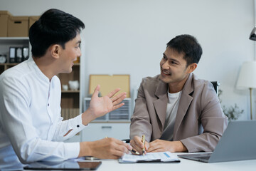 Business team working on a project in the office or reviewing and discussing a business project.