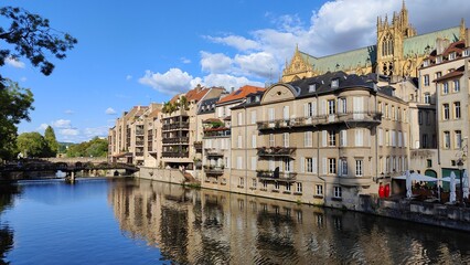 Obraz premium Moselle river in Metz, France. Blue sky, white clouds.