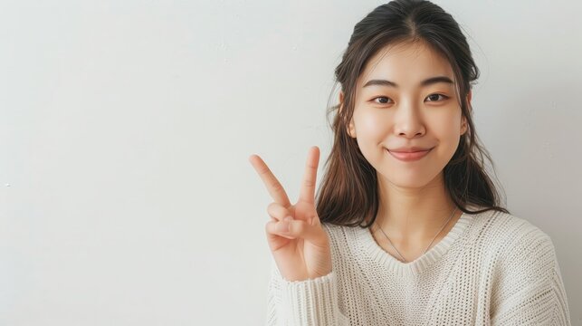 Korean woman doing a peace sign looking friendly w  176 woman, finger, pointing, business, hand, smile, smiling, sign, people, gesture, businesswoman, person, up, success, looking, boy, thumbs up, bea