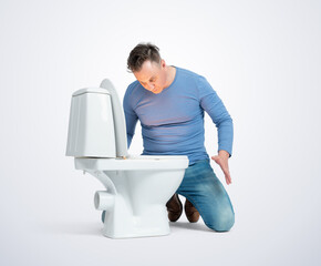 A surprised man in casual clothes, kneeling, looks into the toilet from which a wonderful light is...