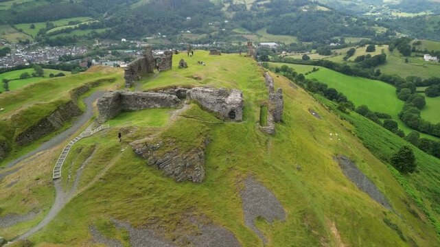 Dinas Br&acirc;n castle, legendary home of the Holy Grail, Wales - aerial tilt up and move over on a moody summer&rsquo;s afternoon