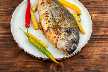 Baked dorado fish with condiment.