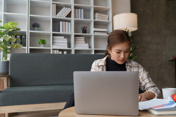 woman meticulously plans a finance audit, using a computer and calculator to review budget...