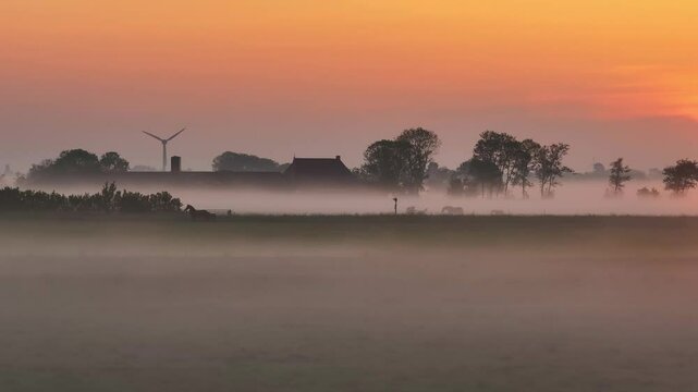 Aerial view of foggy sunrise over rural Makkum, Friesland, Netherlands.