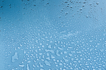Blue backgrond with water drops. Wet glass.